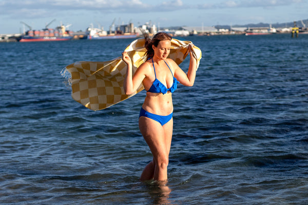 blue frill top and blue bottoms, zero waste swimwear made in new zealand, recycled fabric emroce . emrose . sustainable swimwear